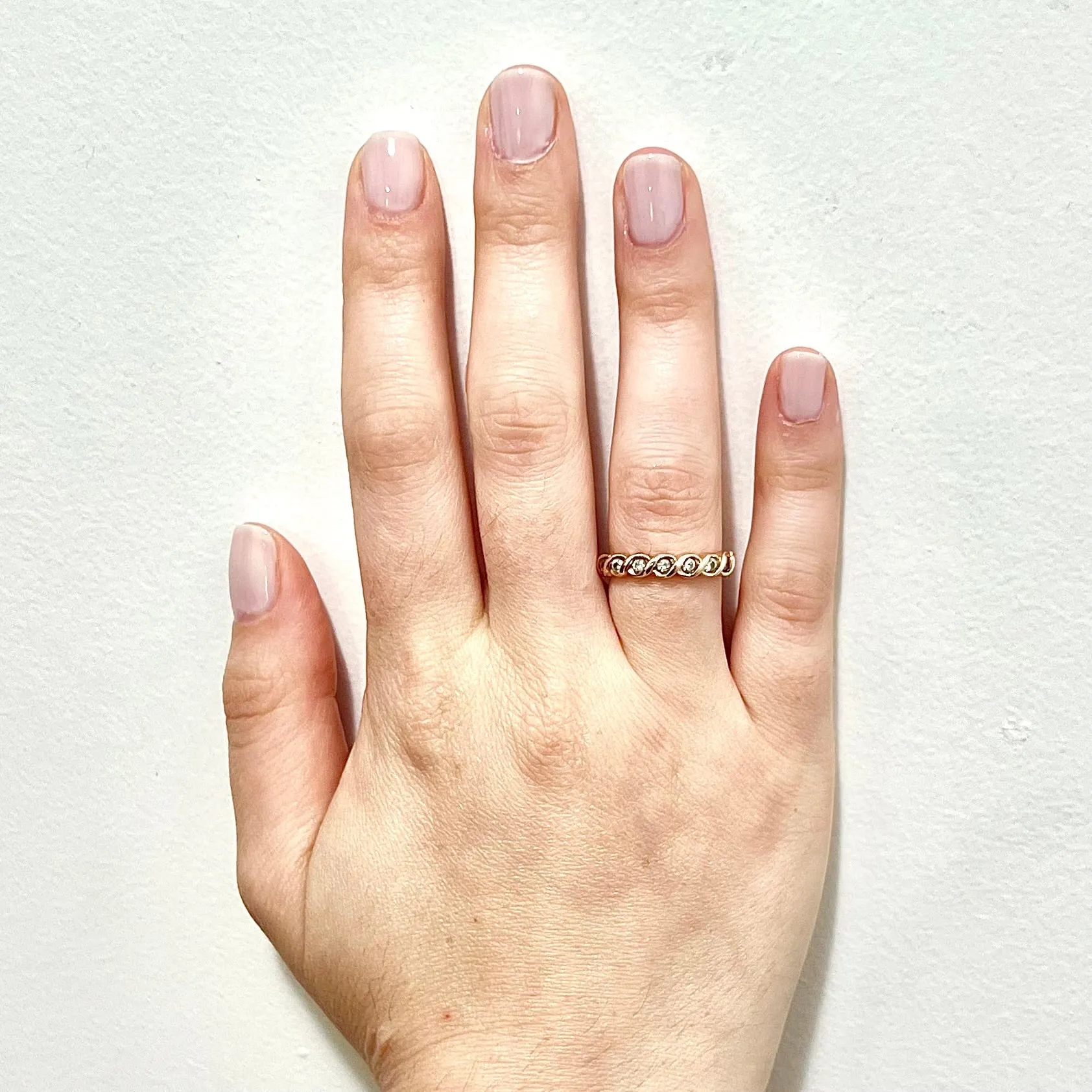 14 Karat Rose Gold Bezel-Set 0.25 Carat Diamond Seven-Stone Band Ring