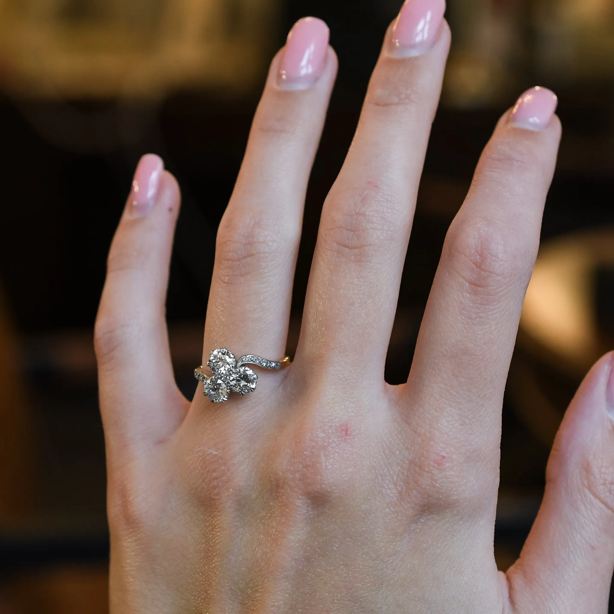 Art Nouveau Three-Stone Diamond Crossover Engagement Ring