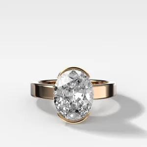 Finest Half Bezel Solitaire Engagement Ring With Oval Cut Diamond