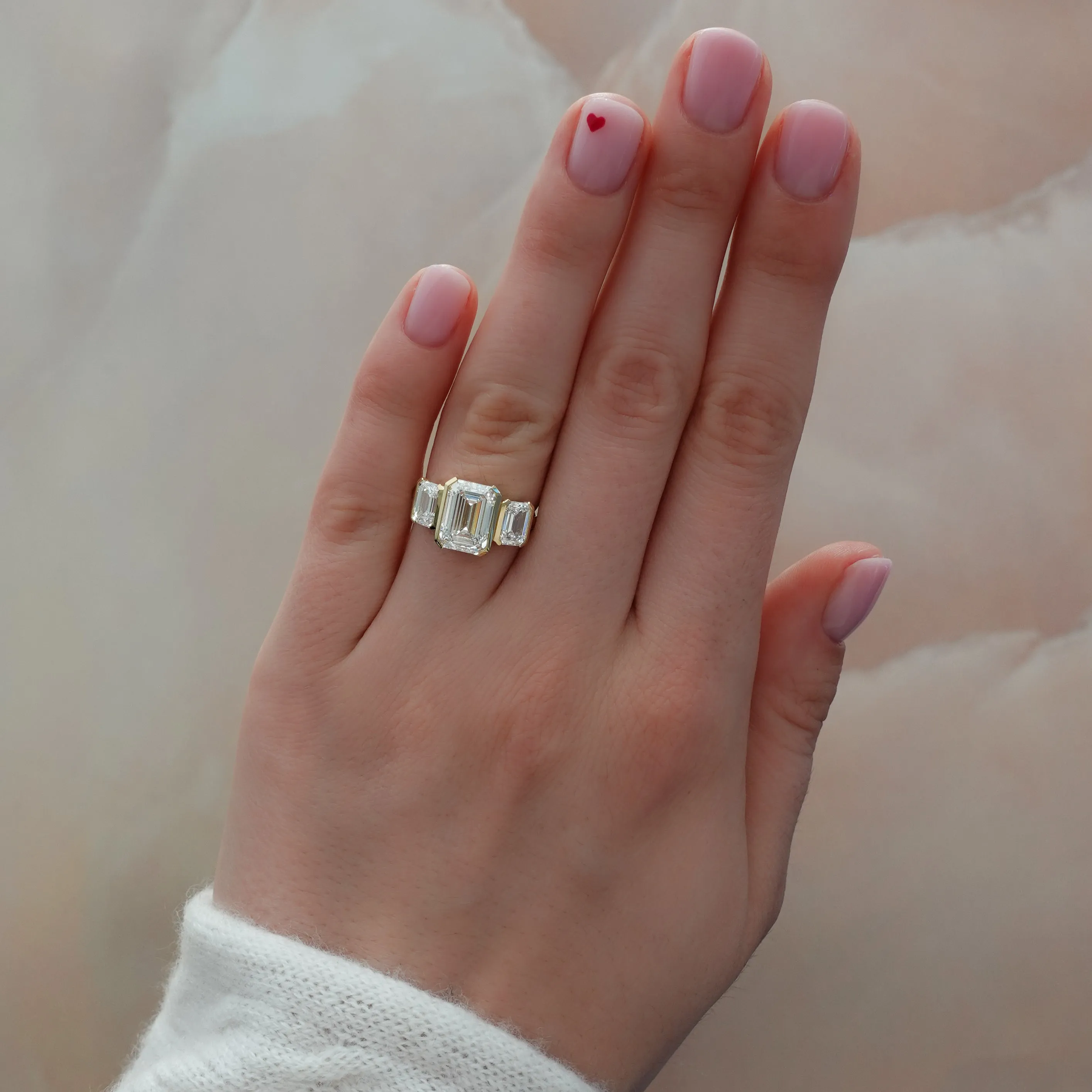 Half Bezel Triad Engagement Ring With Emerald Cut Diamonds