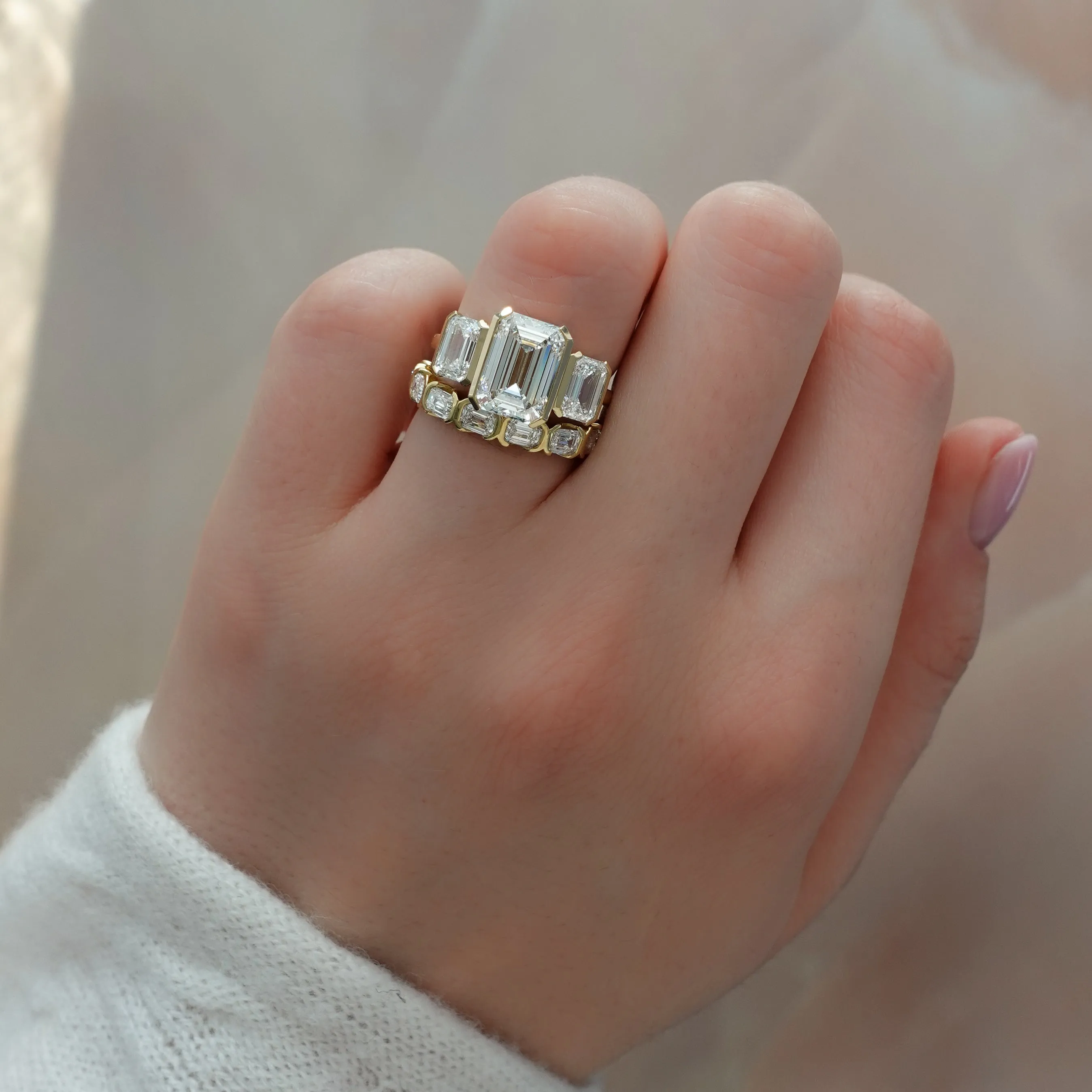 Half Bezel Triad Engagement Ring With Emerald Cut Diamonds