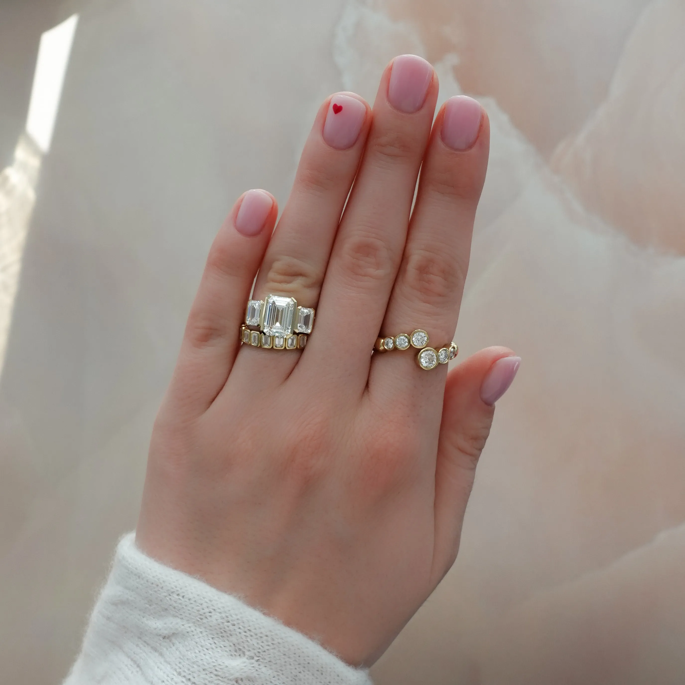 Half Bezel Triad Engagement Ring With Emerald Cut Diamonds